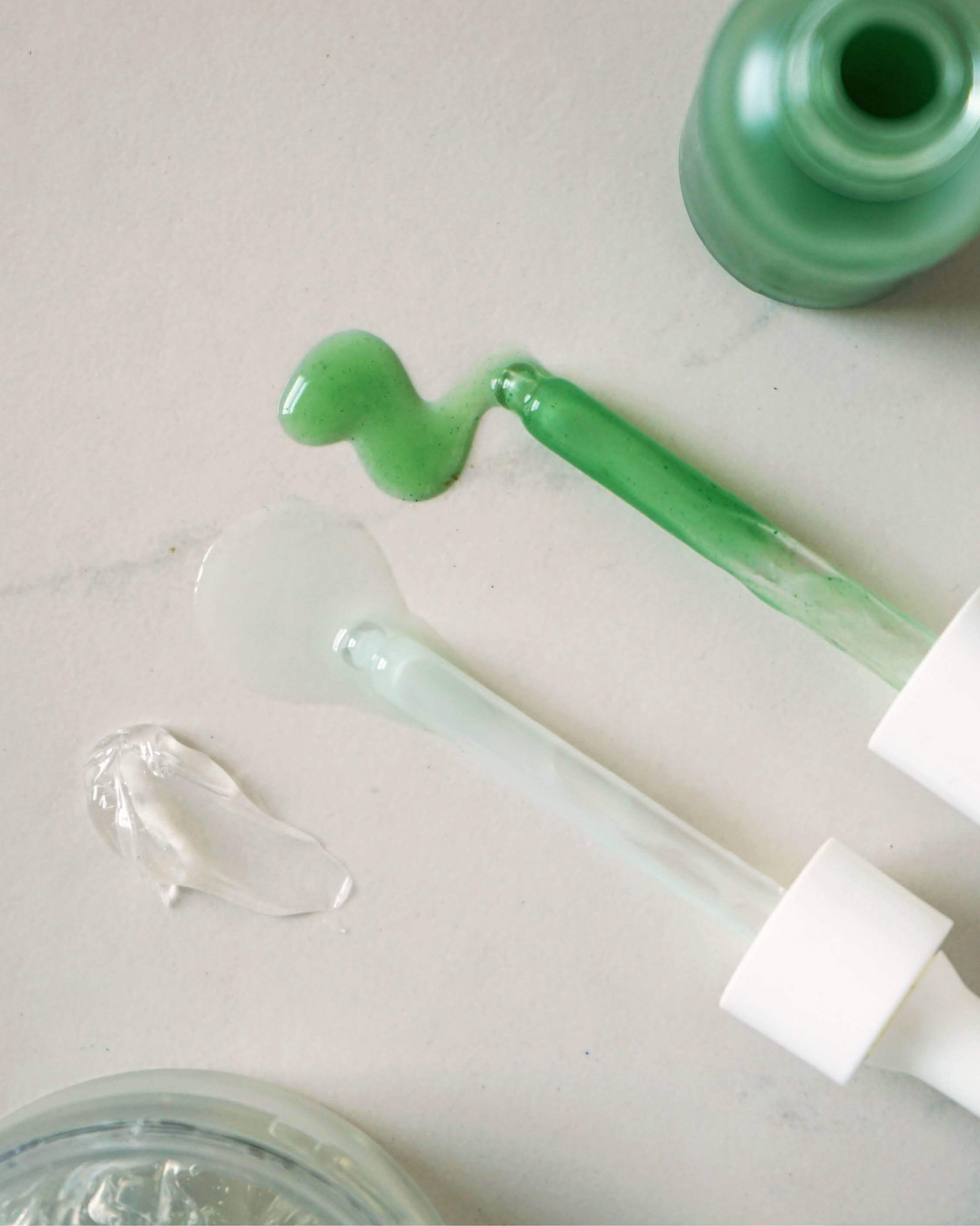 swatches of quandong green booster serum, white tea photo-retinol elixir &amp; fig all-beauty jelly by Ere Perez