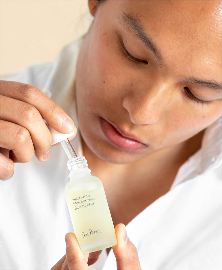 eco-friendly Australian blue cypress face nectar by Ere Perez in its recyclable bottle and applied on the skin for a gentle nutritive effect | 